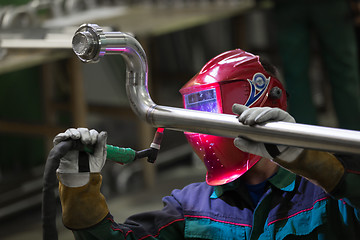 Image showing Industrial worker welding in metal factory.