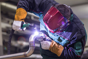 Image showing Industrial worker welding in metal factory.