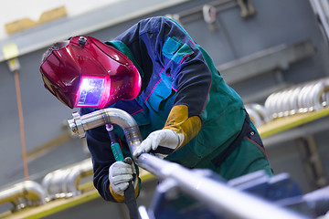 Image showing Industrial worker welding in metal factory.