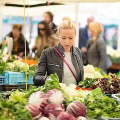 Image showing Woman buying vegetable at local food market. 