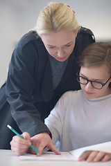 Image showing female teacher helping students on class