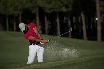 Image showing golfer hitting a sand bunker shot