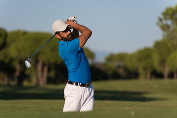 Image showing pro golfer hitting a sand bunker shot