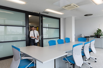 Image showing business people group entering meeting room, motion blur