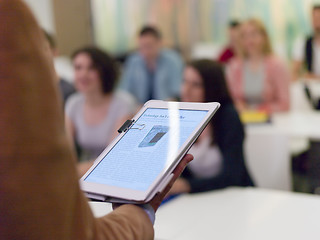 Image showing Closeup  teacher hands and tablet while teaching studens in mode