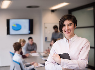 Image showing hispanic businesswoman with tablet at meeting room