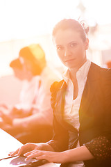 Image showing business woman at  office people group on meeting  in background