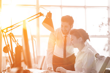 Image showing business couple working together on project, sunrise in backgrou