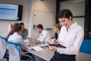 Image showing business woman on meeting  using tablet