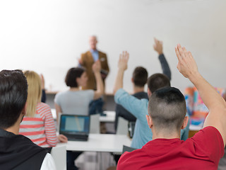 Image showing students group raise hands up on class