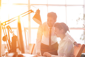 Image showing business couple working together on project, sunrise in backgrou