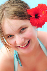 Image showing Portrait of a girl with red flower