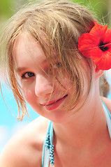 Image showing Portrait of a girl with red flower