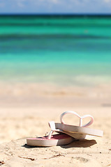 Image showing Flipflops on a sandy beach