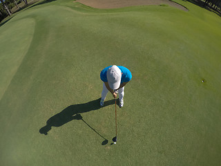 Image showing top view of golf player hitting shot