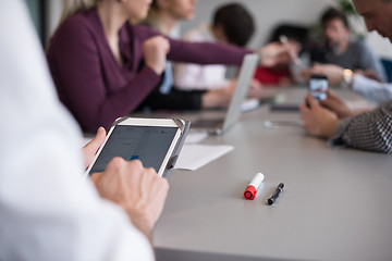 Image showing close up of  businessman hands  using tablet on meeting