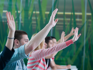 Image showing students group raise hands up on class