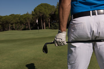 Image showing golf player close up hand and driver from back