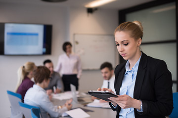 Image showing business woman working on tablet at meeting room