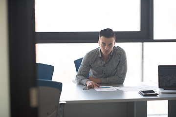 Image showing young businessman at his desk in office