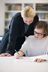 Image showing female teacher helping students on class