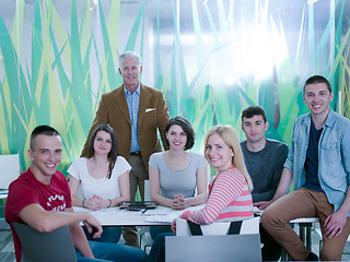 Image showing portrait of in teacher in classroom with students group in backg