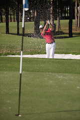 Image showing golfer hitting a sand bunker shot