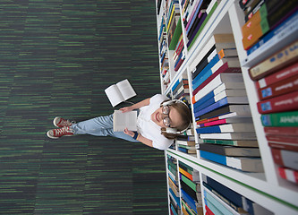 Image showing female student study in library, using tablet and searching for 