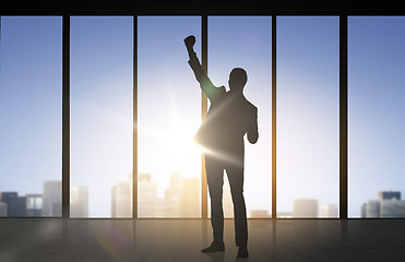 Image showing silhouette of business man over office background