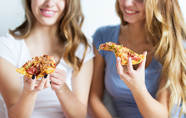 Image showing happy friends or teen girls eating pizza at home