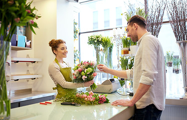 Image showing smiling florist woman and man at flower shop