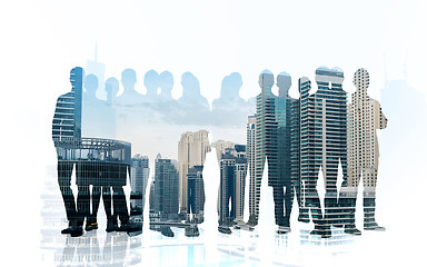 Image showing business people silhouettes over city background