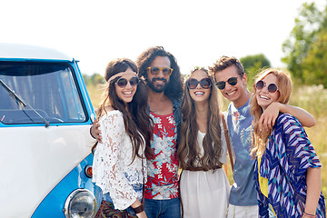 Image showing smiling young hippie friends over minivan car