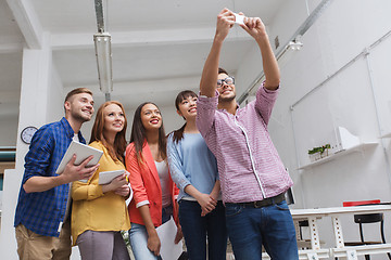 Image showing creative business team taking selfie at office