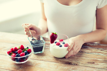 Image showing close up of woman hands with yogurt and berries