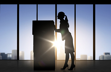 Image showing silhouette of businesswoman moving boxes at office