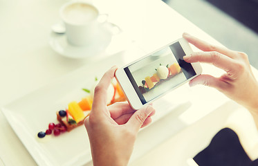 Image showing close up of woman picturing food by smartphone