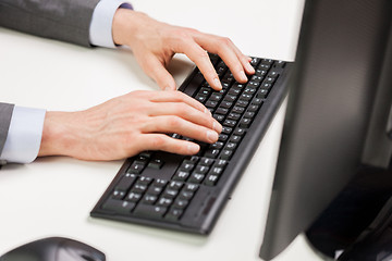 Image showing close up of businessman hands typing on keyboard