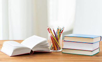 Image showing close up of crayons or color pencils and books