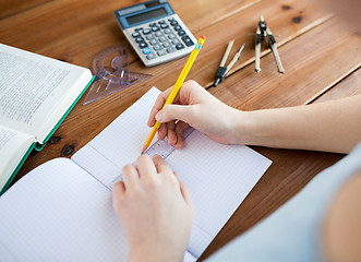 Image showing close up of hands with ruler and pencil drawing