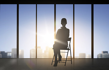 Image showing silhouette of business woman sitting on chair