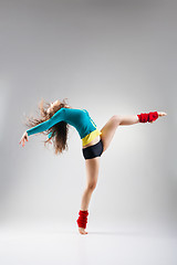 Image showing Modern style dancer  posing on grey background