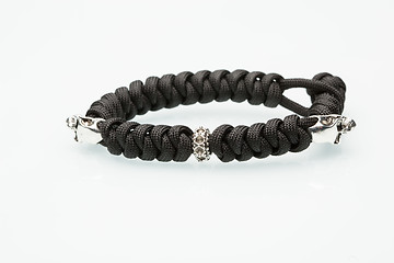 Image showing Black braided bracelet with skulls on white background