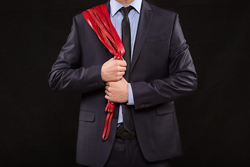 Image showing man in business suit with chained hands. handcuffs for sex games