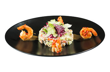 Image showing perfect dish with shrimps on a black plate. seafood. Isolated  white background