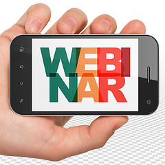 Image showing Studying concept: Hand Holding Smartphone with Webinar on  display