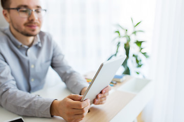 Image showing happy creative male office worker with tablet pc