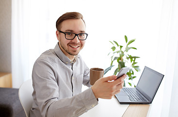 Image showing happy businessman with smarphone and coffee