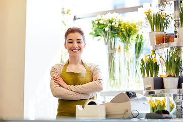 Image showing smiling florist woman at flower shop cashbox