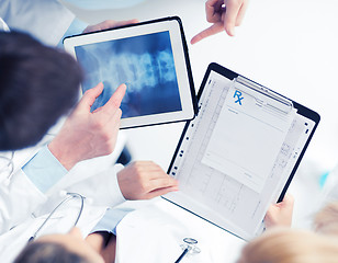 Image showing group of doctors looking at x-ray on tablet pc